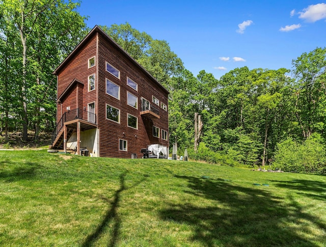 18004 Buckingham Rd, Logan, OH 43138 - view of property exterior featuring stairs, a lawn, and a wooden deck