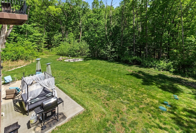 18004 Buckingham Rd, Logan, OH 43138 - view of grassy yard with an outdoor fire pit, a patio, and a wooden deck