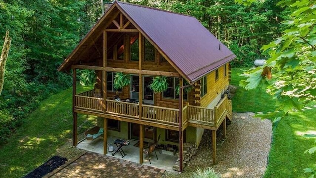 back of property featuring a lawn and a patio