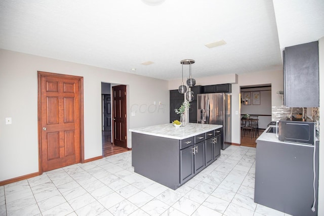 kitchen featuring pendant lighting, stainless steel fridge with ice dispenser, and a kitchen island