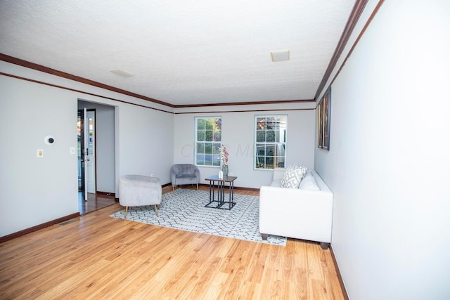 unfurnished living room with hardwood / wood-style flooring, crown molding, and a textured ceiling