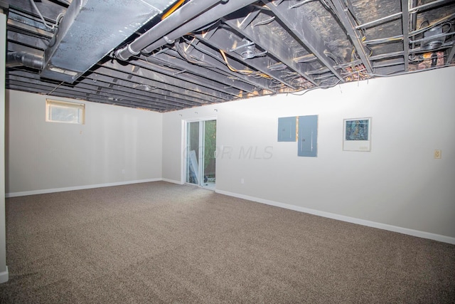 basement featuring carpet flooring and electric panel