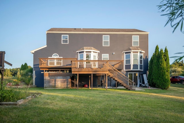 rear view of house featuring a yard and a deck