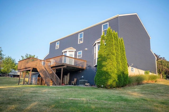 back of property featuring central AC, a deck, and a lawn