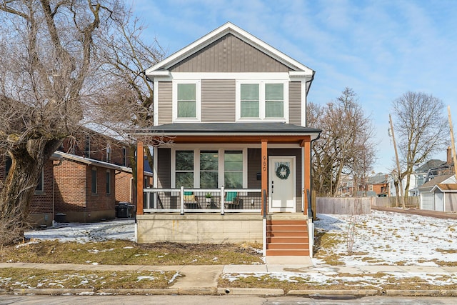 traditional-style home featuring covered porch and board and batten siding