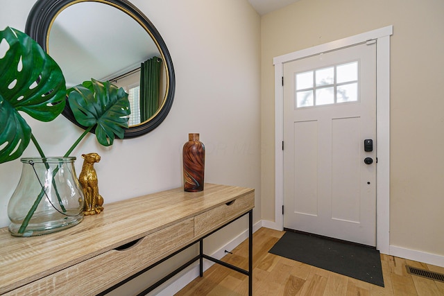 entrance foyer with light wood-type flooring, visible vents, and baseboards