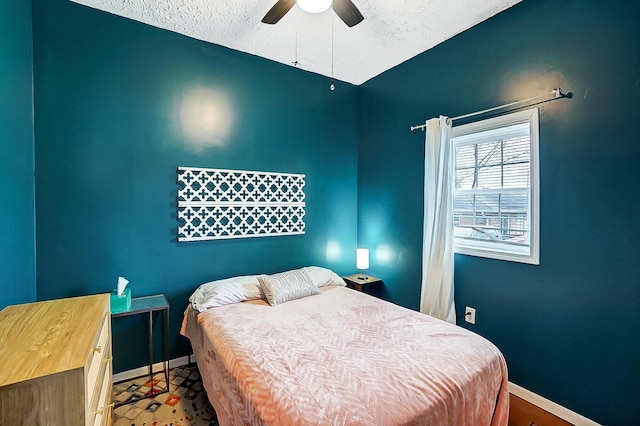 bedroom featuring a textured ceiling and ceiling fan
