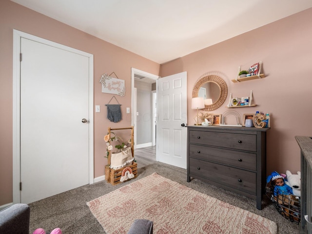 bedroom featuring light colored carpet and baseboards