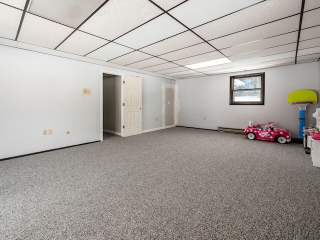 below grade area with carpet, a drop ceiling, and baseboards