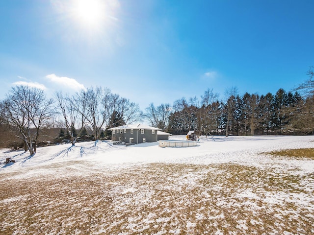 snowy yard with a covered pool