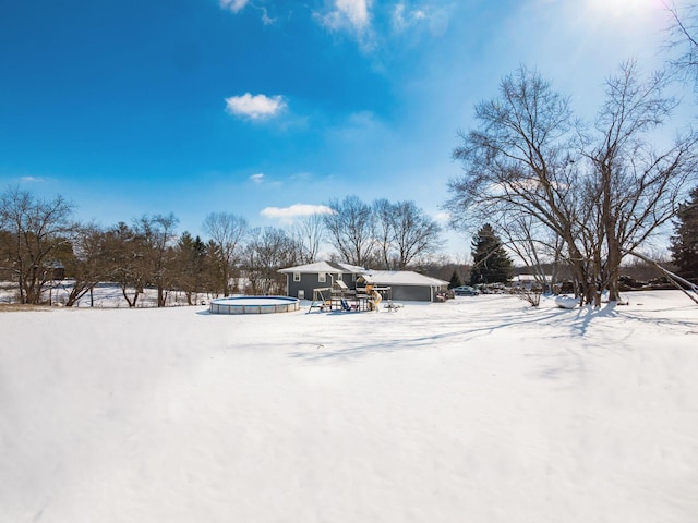 yard covered in snow with an outdoor pool