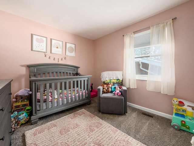 carpeted bedroom featuring a nursery area, visible vents, and baseboards