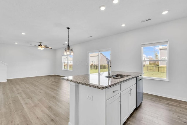 kitchen featuring stainless steel dishwasher, a sink, visible vents, and recessed lighting