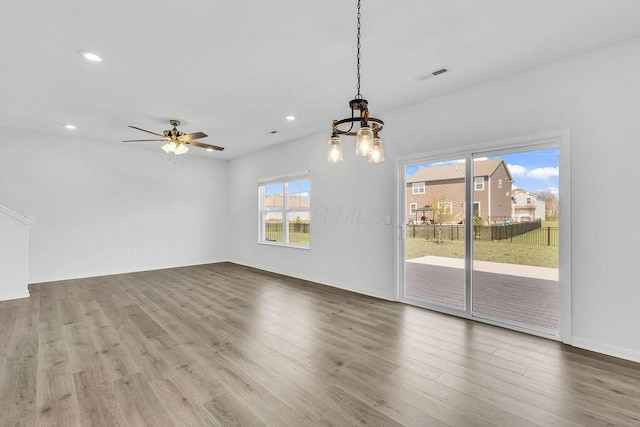 unfurnished dining area featuring baseboards, wood finished floors, visible vents, and recessed lighting