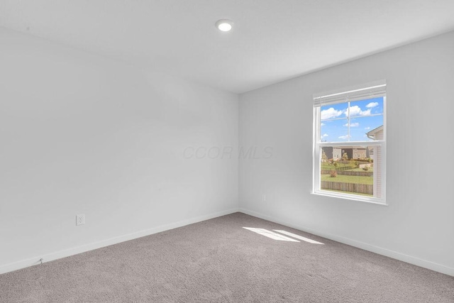 carpeted empty room featuring baseboards and recessed lighting