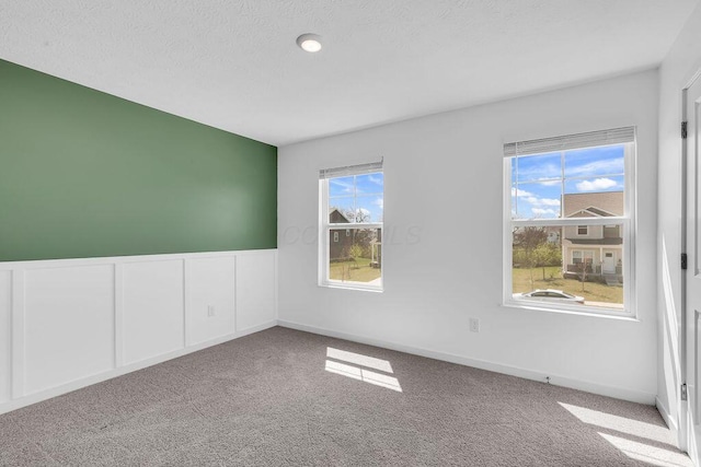empty room with baseboards and carpet flooring