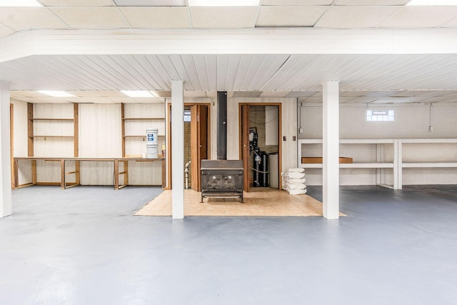 finished basement featuring a wood stove