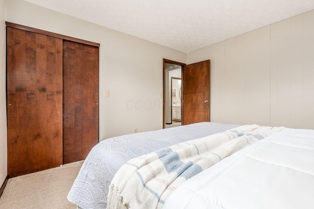 carpeted bedroom featuring a textured ceiling