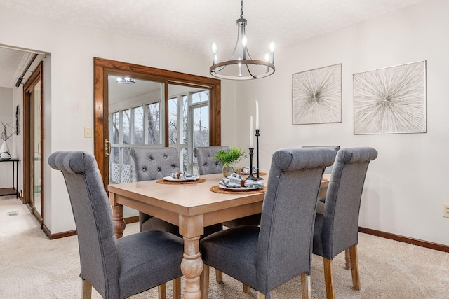 dining area with baseboards, light carpet, and a chandelier