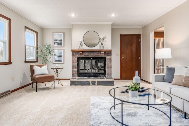 living room with a brick fireplace, carpet flooring, visible vents, and ornamental molding