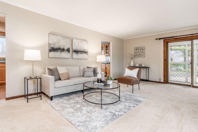 living area featuring light colored carpet, crown molding, and baseboards