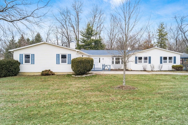 single story home featuring a front lawn and a chimney