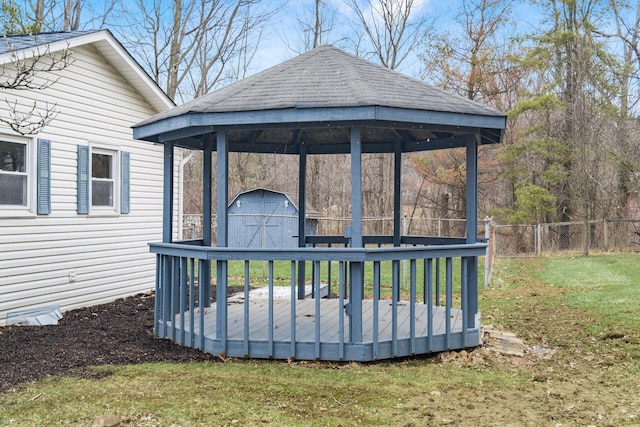 exterior space with an outbuilding, fence, a shed, a yard, and a gazebo