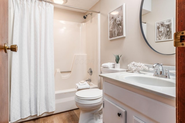 bathroom featuring shower / bath combination with curtain, vanity, toilet, and wood finished floors