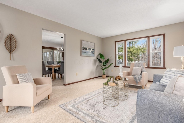 living room featuring an inviting chandelier, carpet, and baseboards