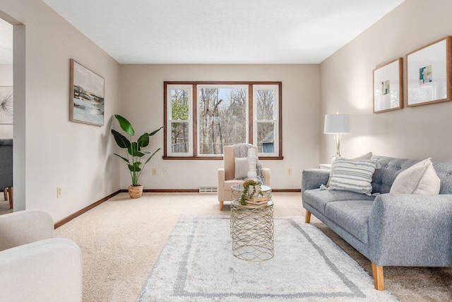 living room featuring visible vents, baseboards, and carpet flooring