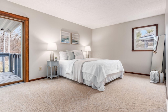 bedroom featuring access to exterior, light colored carpet, baseboards, and a textured ceiling