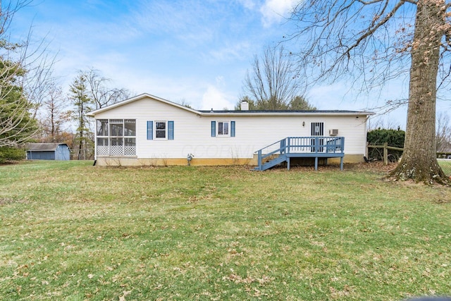 rear view of property featuring an outbuilding, a wooden deck, a sunroom, a chimney, and a lawn