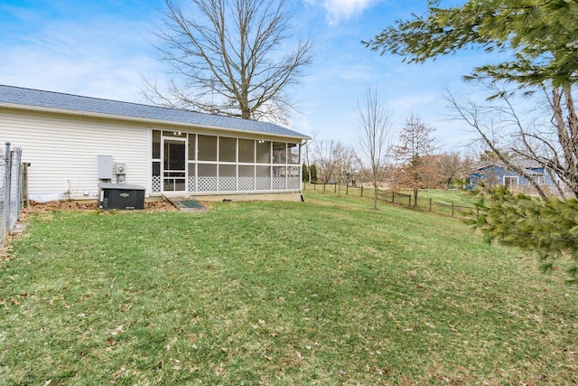 view of yard featuring a fenced backyard and a sunroom