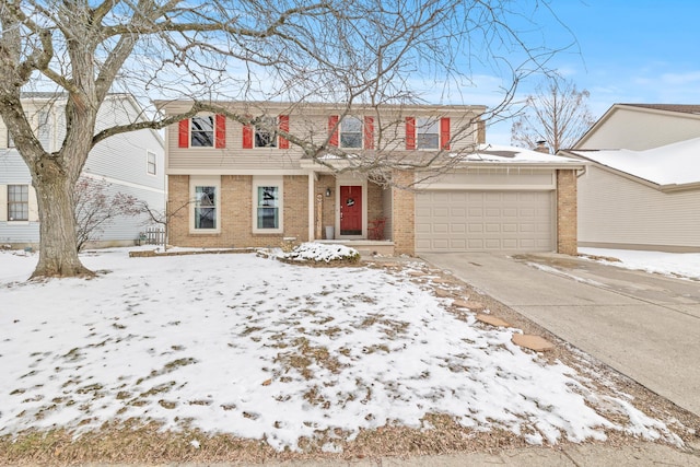 view of front of house with driveway, an attached garage, and brick siding