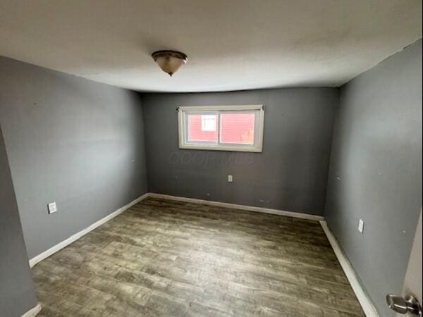 spare room with dark hardwood / wood-style floors