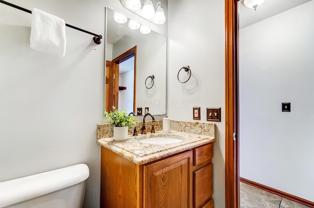 bathroom with toilet and vanity