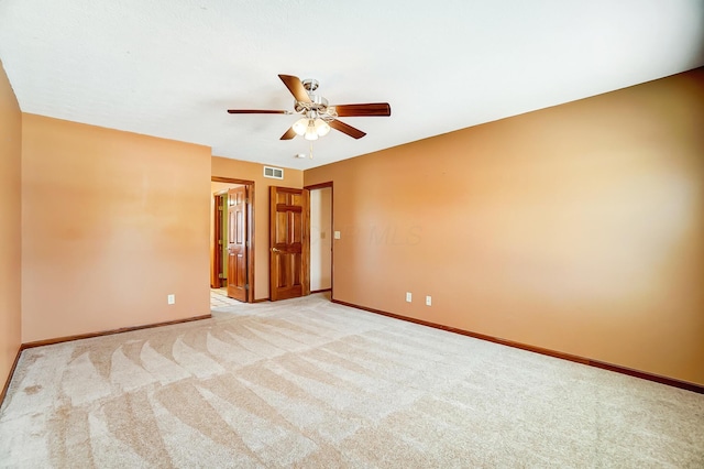 carpeted empty room featuring ceiling fan