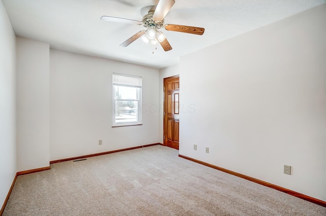 carpeted empty room featuring ceiling fan