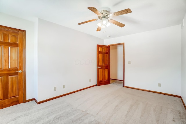 carpeted spare room with ceiling fan