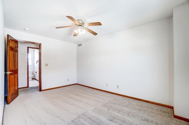 empty room with ceiling fan and light colored carpet