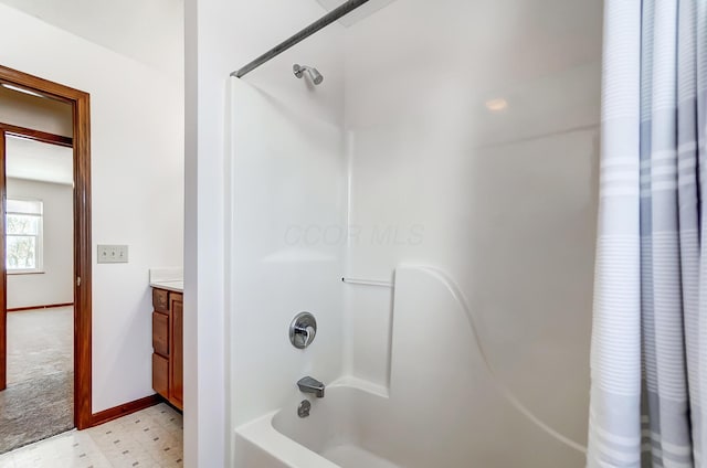 bathroom with shower / bath combo with shower curtain and vanity