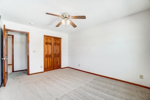 unfurnished bedroom with light carpet, ceiling fan, and a closet