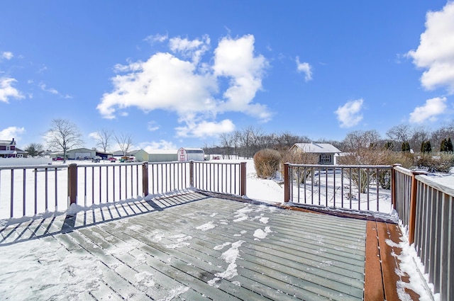 snow covered deck with a storage unit