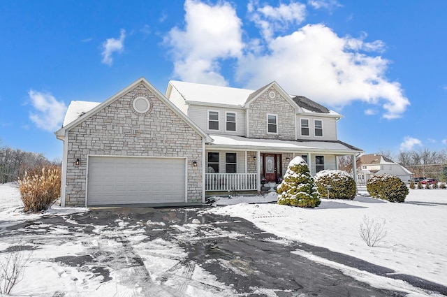 view of front property featuring covered porch and a garage