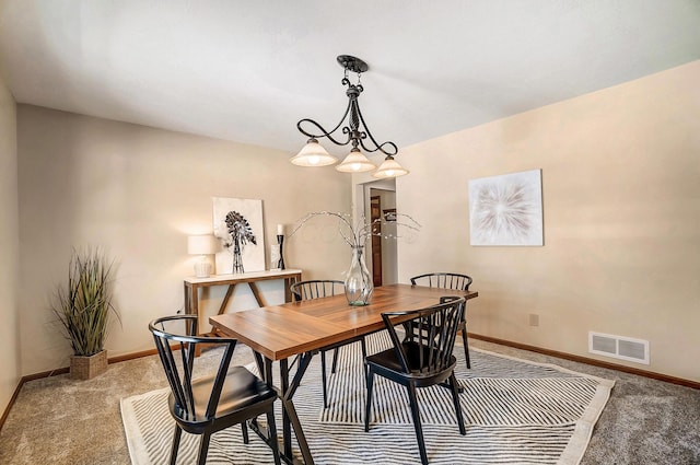 dining space with light colored carpet