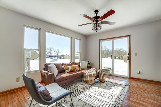 living room with light wood-type flooring and ceiling fan