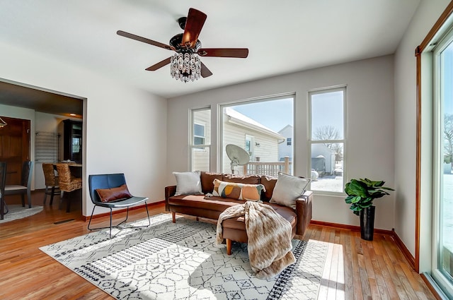 living area featuring ceiling fan and light hardwood / wood-style floors