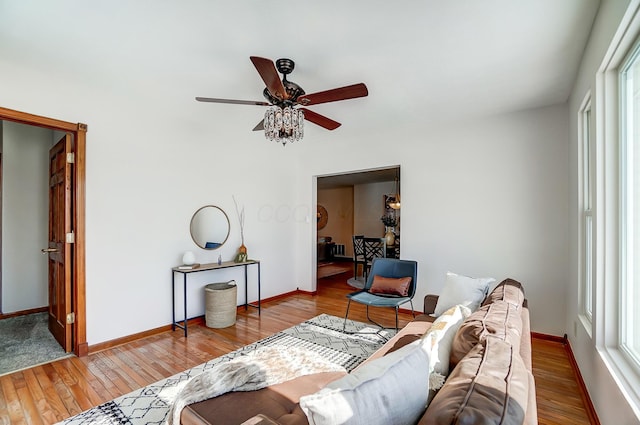 living room featuring ceiling fan and light hardwood / wood-style floors