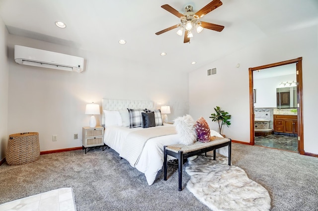 carpeted bedroom with ceiling fan, a wall unit AC, and ensuite bath