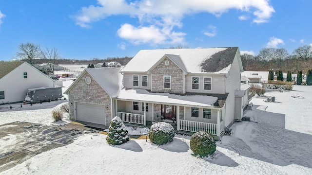 view of front of house featuring covered porch and a garage